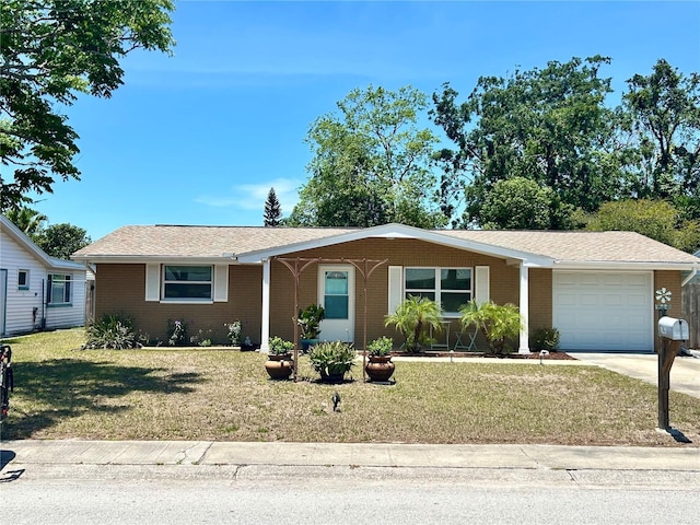 7861 Raintree Dr, New Port Richey, FL 34653 - single story home with an attached garage, brick siding, and a front lawn