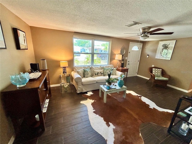 7861 Raintree Dr, New Port Richey, FL 34653 - living room with a textured ceiling, ceiling fan, dark wood finished floors, and baseboards