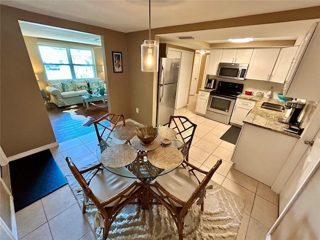 7861 Raintree Dr, New Port Richey, FL 34653 - dining room featuring light tile patterned flooring and baseboards