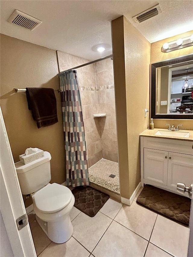 7861 Raintree Dr, New Port Richey, FL 34653 - full bath featuring toilet, a textured wall, vanity, a tile shower, and tile patterned flooring