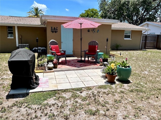 7861 Raintree Dr, New Port Richey, FL 34653 - rear view of property featuring stucco siding, a patio, and central air condition unit