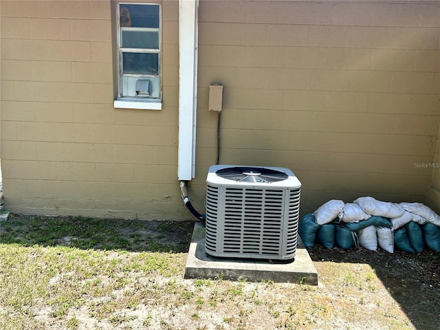 7861 Raintree Dr, New Port Richey, FL 34653 - exterior view of central AC and concrete block siding