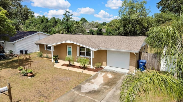 7861 Raintree Dr, New Port Richey, FL 34653 - single story home featuring an attached garage, brick siding, a shingled roof, and driveway