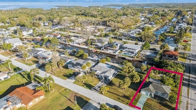 5447 Quist Dr, Port Richey, FL 34668 - aerial perspective of suburban area featuring property parcel outlined and a nearby body of water