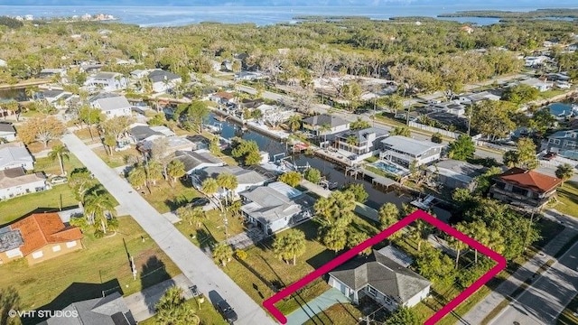 5447 Quist Dr, Port Richey, FL 34668 - aerial view of property and surrounding area featuring property boundaries highlighted, nearby suburban area, and a large body of water