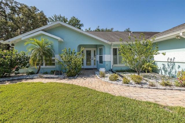 3609 Montclair Dr, New Port Richey, FL 34655 - ranch-style home featuring stucco siding, a front yard, and french doors