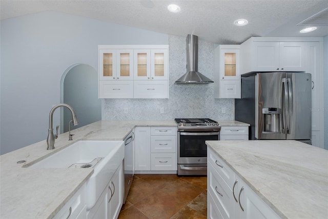 3609 Montclair Dr, New Port Richey, FL 34655 - kitchen featuring wall chimney exhaust hood, stainless steel appliances, decorative backsplash, light stone countertops, and lofted ceiling