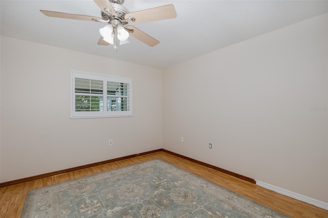 3609 Montclair Dr, New Port Richey, FL 34655 - empty room with baseboards, ceiling fan, and wood finished floors
