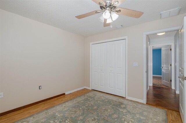 3609 Montclair Dr, New Port Richey, FL 34655 - unfurnished bedroom with wood finished floors, baseboards, and a closet