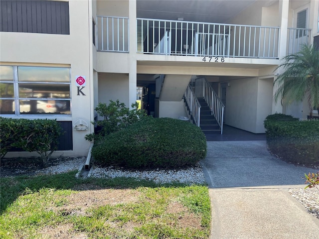 4726 Marine Pkwy Unit 104, New Port Richey, FL 34652 - view of building exterior with stairway and a carport