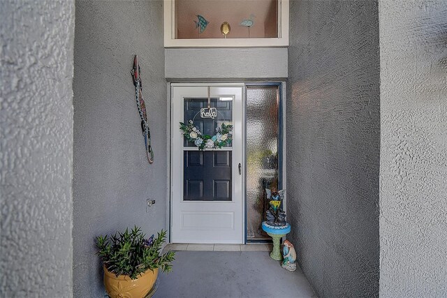 14011 Shoal Dr, Hudson, FL 34667 - view of exterior entry featuring stucco siding
