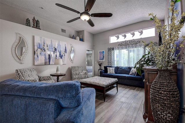 14011 Shoal Dr, Hudson, FL 34667 - living area featuring light wood-style floors, a ceiling fan, a textured ceiling, and a high ceiling