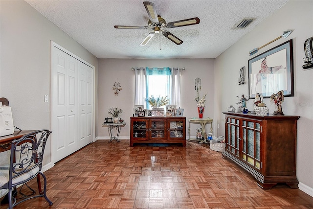 14011 Shoal Dr, Hudson, FL 34667 - foyer featuring a ceiling fan, a textured ceiling, and baseboards
