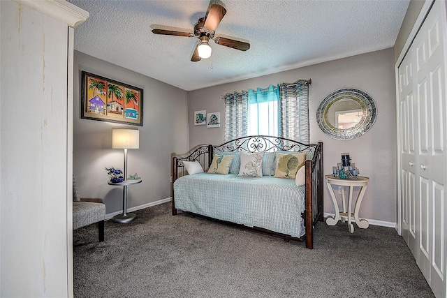 14011 Shoal Dr, Hudson, FL 34667 - bedroom featuring a closet, carpet, a textured ceiling, baseboards, and a ceiling fan