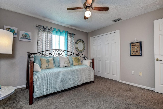 14011 Shoal Dr, Hudson, FL 34667 - carpeted bedroom with a closet, a textured ceiling, baseboards, and a ceiling fan