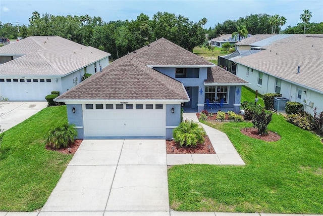 14011 Shoal Dr, Hudson, FL 34667 - view of front of house with a shingled roof, stucco siding, concrete driveway, a front yard, and a garage