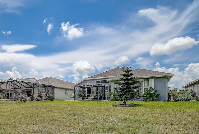 14011 Shoal Dr, Hudson, FL 34667 - rear view of house with a yard, stucco siding, and a lanai