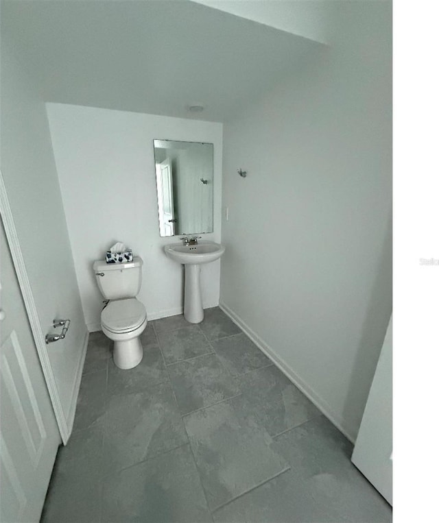 7433 Stone Creek Trl, Kissimmee, FL 34747 - half bathroom featuring toilet, baseboards, and tile patterned floors