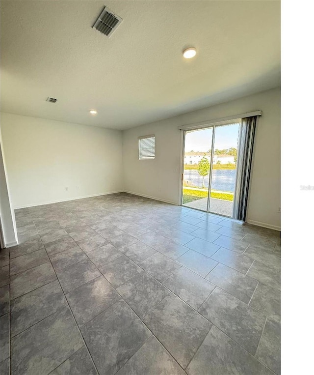 7433 Stone Creek Trl, Kissimmee, FL 34747 - tiled spare room with baseboards and recessed lighting