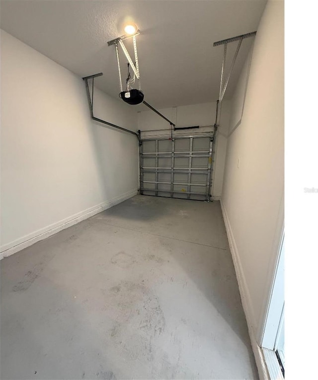 7433 Stone Creek Trl, Kissimmee, FL 34747 - garage featuring a garage door opener and baseboards