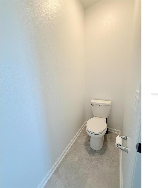 7433 Stone Creek Trl, Kissimmee, FL 34747 - bathroom with toilet, baseboards, and tile patterned flooring