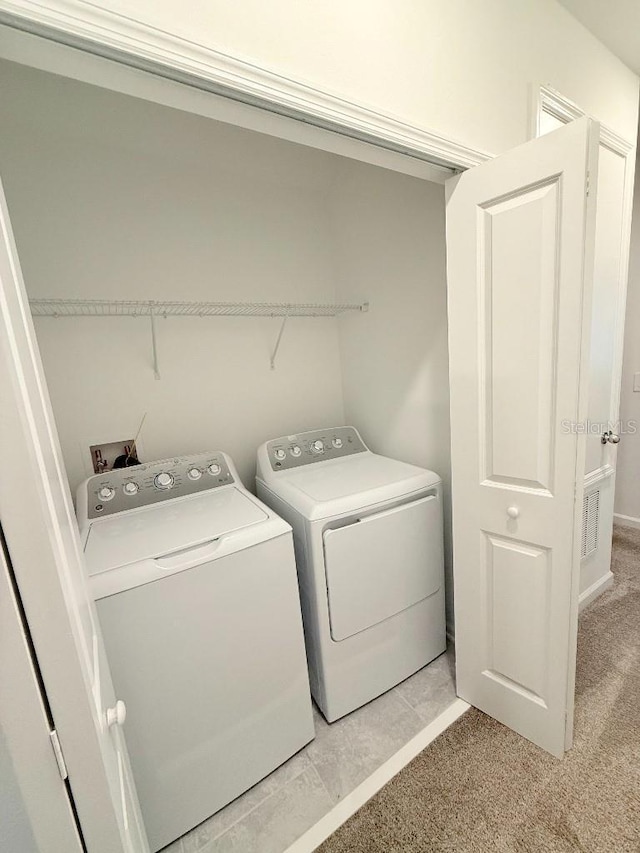 7433 Stone Creek Trl, Kissimmee, FL 34747 - laundry room featuring washer and dryer and light carpet
