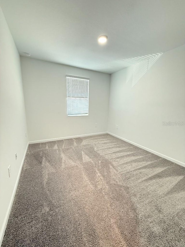 7433 Stone Creek Trl, Kissimmee, FL 34747 - spare room with carpet and baseboards