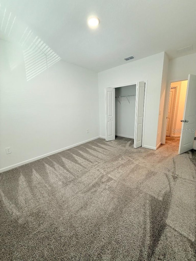 7433 Stone Creek Trl, Kissimmee, FL 34747 - unfurnished bedroom featuring carpet flooring, baseboards, and a closet