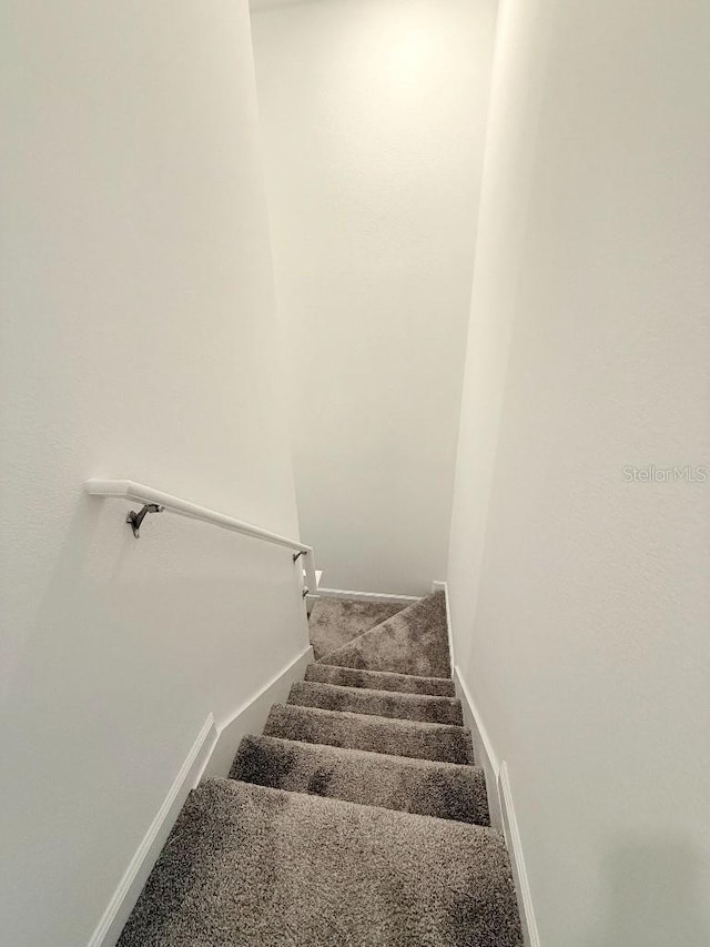 7433 Stone Creek Trl, Kissimmee, FL 34747 - staircase featuring baseboards and carpet flooring
