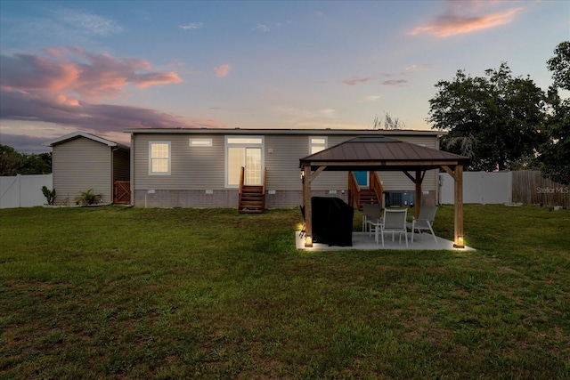 9408 Century Dr, Spring Hill, FL 34606 - back of house at dusk with entry steps, a gazebo, and a patio
