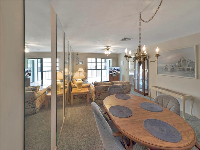 5627 Ferguson Ct Unit 1303, New Port Richey, FL 34652 - dining area featuring a ceiling fan, a chandelier, and carpet floors