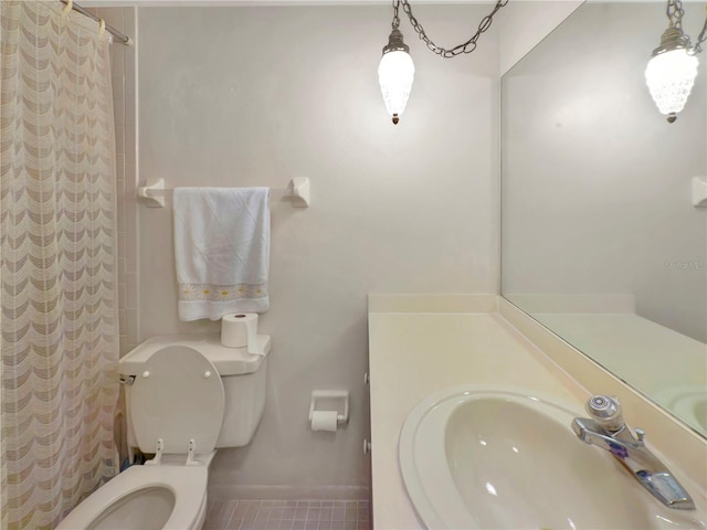 5627 Ferguson Ct Unit 1303, New Port Richey, FL 34652 - bathroom with toilet, a shower with shower curtain, vanity, and baseboards