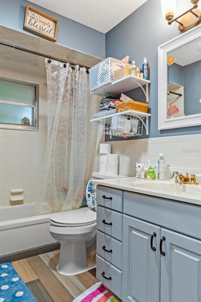 8102 Fort Dade Ave, Brooksville, FL 34601 - bathroom with vanity, wood finished floors, toilet, shower / bath combo with shower curtain, and tile walls