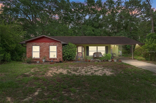 8102 Fort Dade Ave, Brooksville, FL 34601 - ranch-style home with driveway, an attached carport, and brick siding