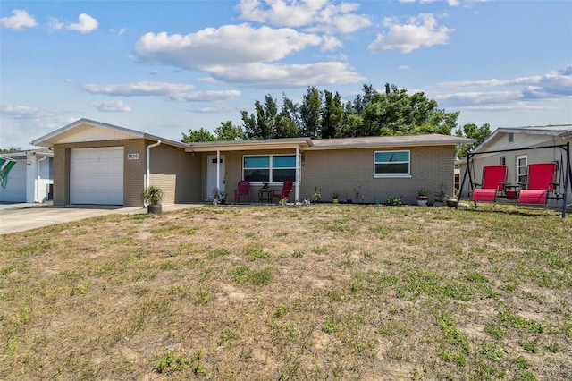 7830 Ilex Dr, Port Richey, FL 34668 - single story home with brick siding, an attached garage, a front yard, and driveway