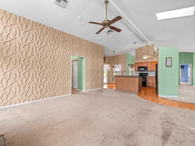 10442 Ventura Dr, Spring Hill, FL 34608 - unfurnished living room featuring light colored carpet, beamed ceiling, baseboards, ceiling fan, and wallpapered walls