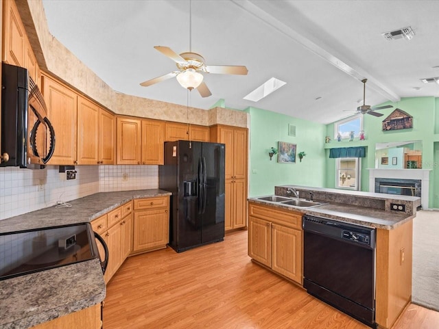 10442 Ventura Dr, Spring Hill, FL 34608 - kitchen featuring black appliances, a ceiling fan, a sink, light wood-style flooring, and a glass covered fireplace
