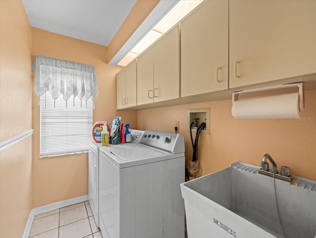 10442 Ventura Dr, Spring Hill, FL 34608 - washroom with cabinet space, washing machine and dryer, baseboards, and light tile patterned floors