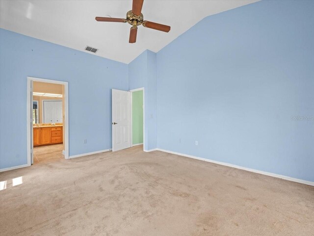 10442 Ventura Dr, Spring Hill, FL 34608 - unfurnished bedroom with light carpet, baseboards, high vaulted ceiling, ensuite bathroom, and a ceiling fan