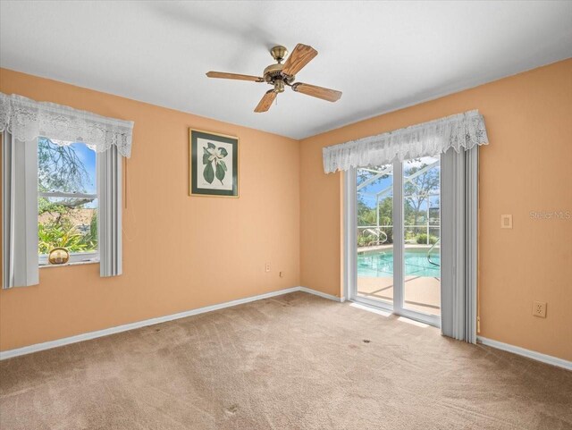 10442 Ventura Dr, Spring Hill, FL 34608 - spare room featuring healthy amount of natural light, carpet, and baseboards