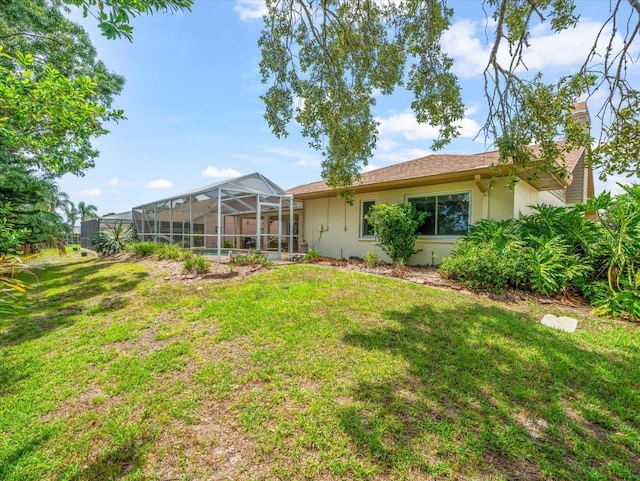 10442 Ventura Dr, Spring Hill, FL 34608 - rear view of property with stucco siding, a yard, glass enclosure, and a chimney