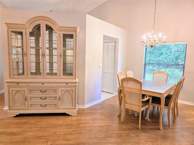 3627 Muirfield Ct Unit 3627, New Port Richey, FL 34655 - dining room featuring a chandelier, baseboards, and light wood finished floors