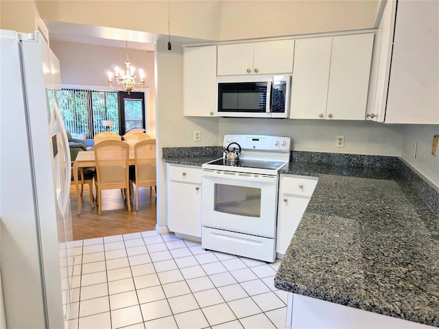 3627 Muirfield Ct Unit 3627, New Port Richey, FL 34655 - kitchen featuring white appliances, a chandelier, white cabinetry, and light tile patterned floors