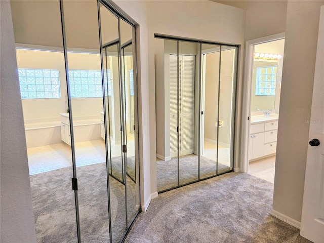 3627 Muirfield Ct Unit 3627, New Port Richey, FL 34655 - unfurnished bedroom featuring carpet, multiple closets, connected bathroom, and baseboards