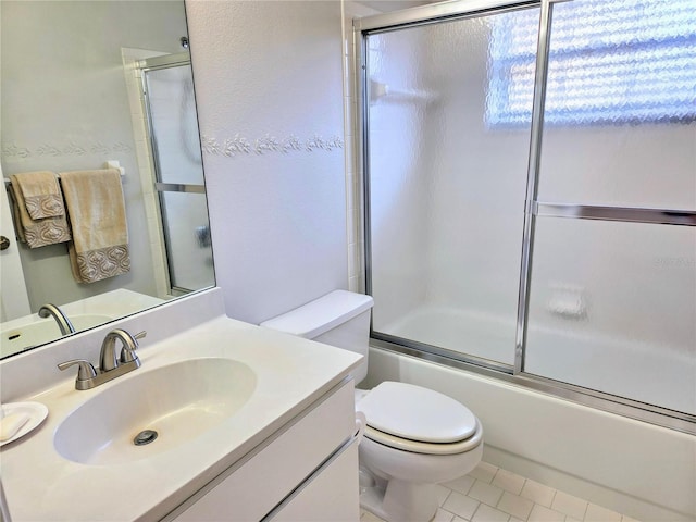 3627 Muirfield Ct Unit 3627, New Port Richey, FL 34655 - full bath featuring toilet, vanity, combined bath / shower with glass door, and tile patterned flooring