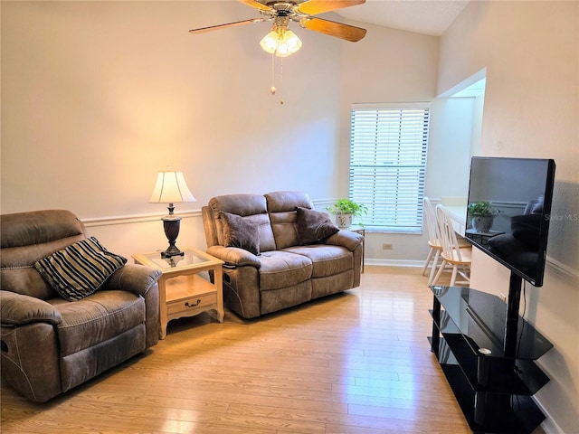 3627 Muirfield Ct Unit 3627, New Port Richey, FL 34655 - living area with a ceiling fan, light wood-type flooring, baseboards, and vaulted ceiling