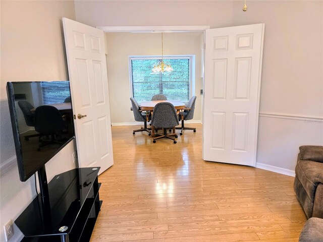 3627 Muirfield Ct Unit 3627, New Port Richey, FL 34655 - dining space with light wood-style flooring, a chandelier, baseboards, and an office area