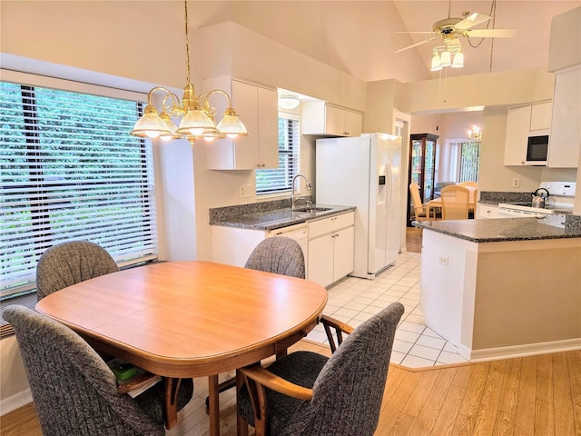3627 Muirfield Ct Unit 3627, New Port Richey, FL 34655 - kitchen with white appliances, a sink, ceiling fan, white cabinets, and a towering ceiling
