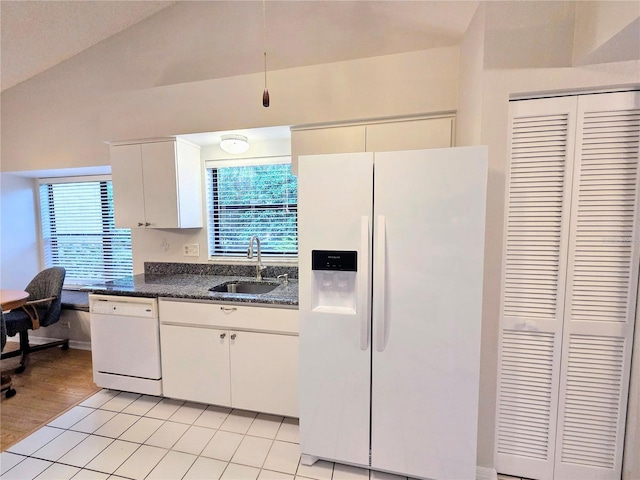 3627 Muirfield Ct Unit 3627, New Port Richey, FL 34655 - kitchen featuring white appliances, a sink, healthy amount of natural light, white cabinets, and vaulted ceiling