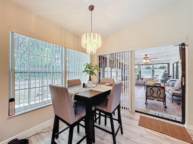 10411 Ireland St, Spring Hill, FL 34608 - dining area featuring light wood finished floors, a chandelier, baseboards, and ceiling fan